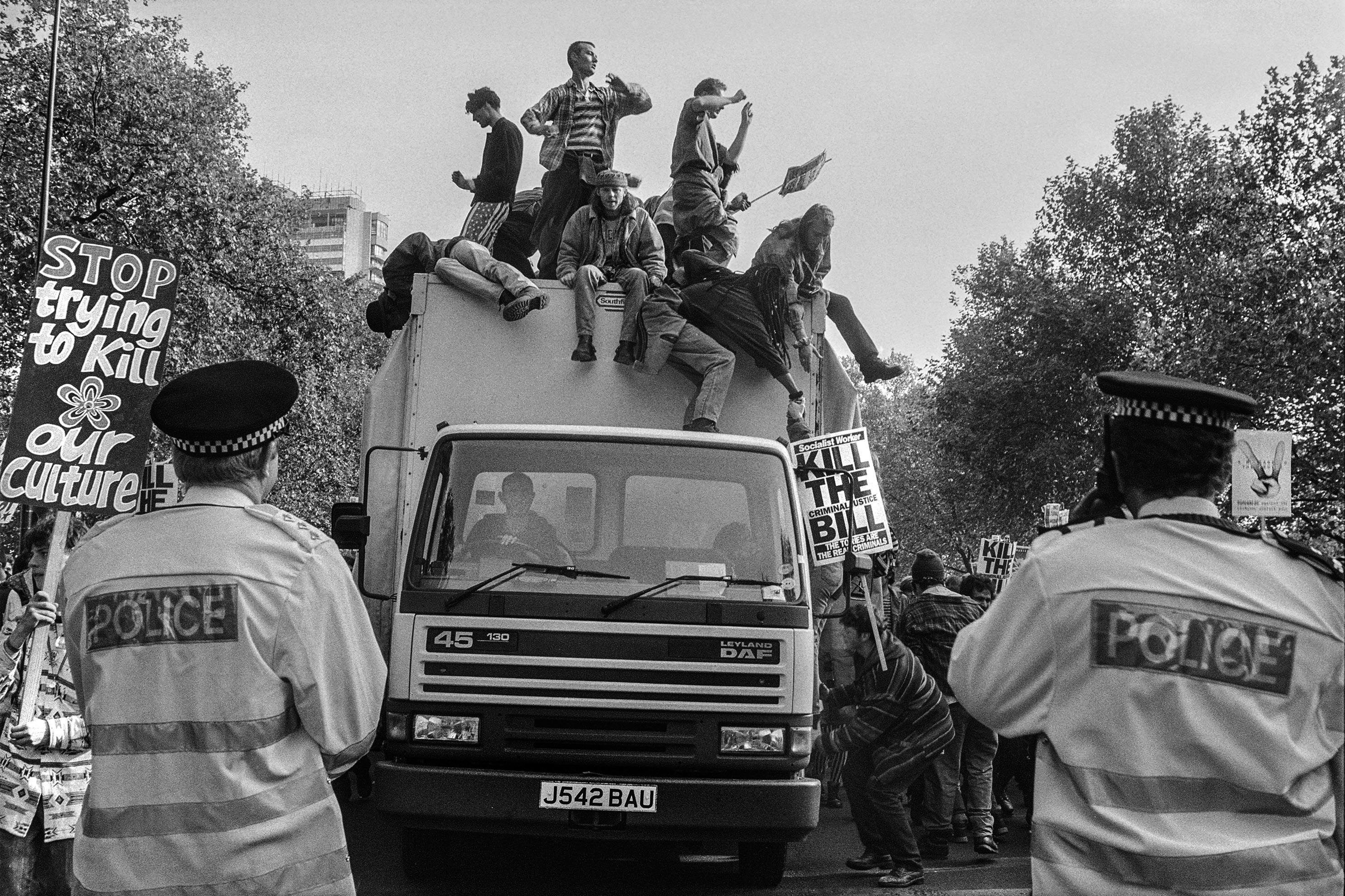 Matt Smith Anti CJB March In London, Smokescreen Lorry With Love Cabbage On Protesters Sign Stop Killing Our Culture Flanked By Police